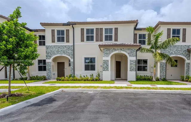 a view of a house with swimming pool and a small yard
