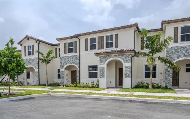 a kitchen with kitchen island granite countertop white cabinets and stainless steel appliances