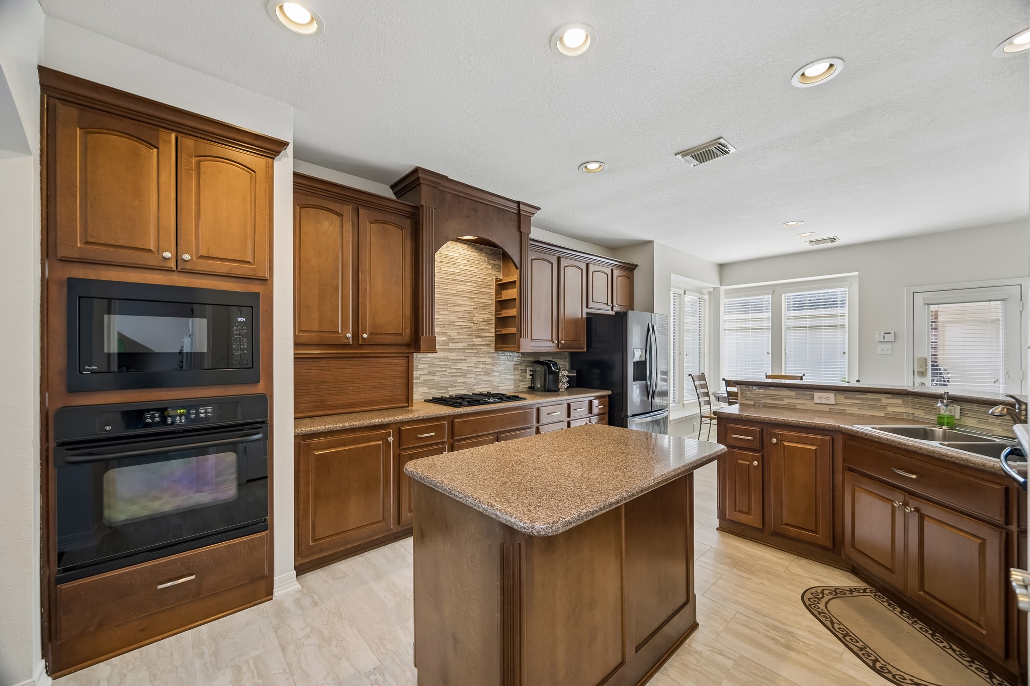 5718 Brennan Ridge Lane Katy, TX 77450 - Photo 5 of 42 THOUGHTFUL DESIGN MEETS EVERYDAY FUNCTION: Complete with a center island, generous prep space, abundant storage, appliance garage, and a large walk-in pantry, this kitchen was designed to handle everything from busy mornings to holiday entertaining.