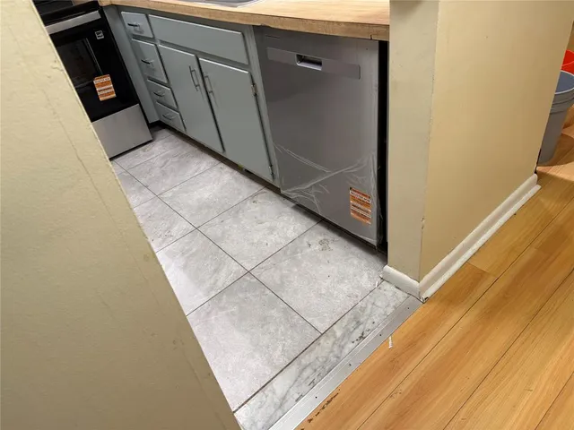 a view of an empty room with a sink and dishwasher