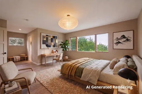 a view of a livingroom with workspace and a window
