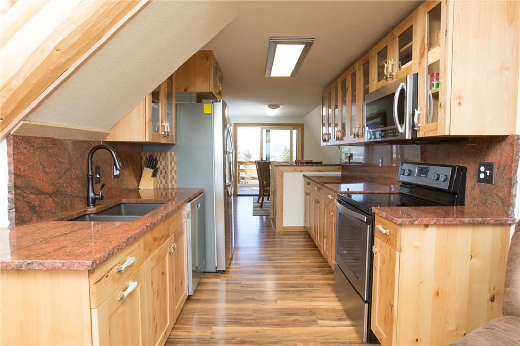 377 Sheep Ridge Road Fairplay, CO 80440 - Photo 13 of 35 a kitchen with stainless steel appliances granite countertop a stove and a sink