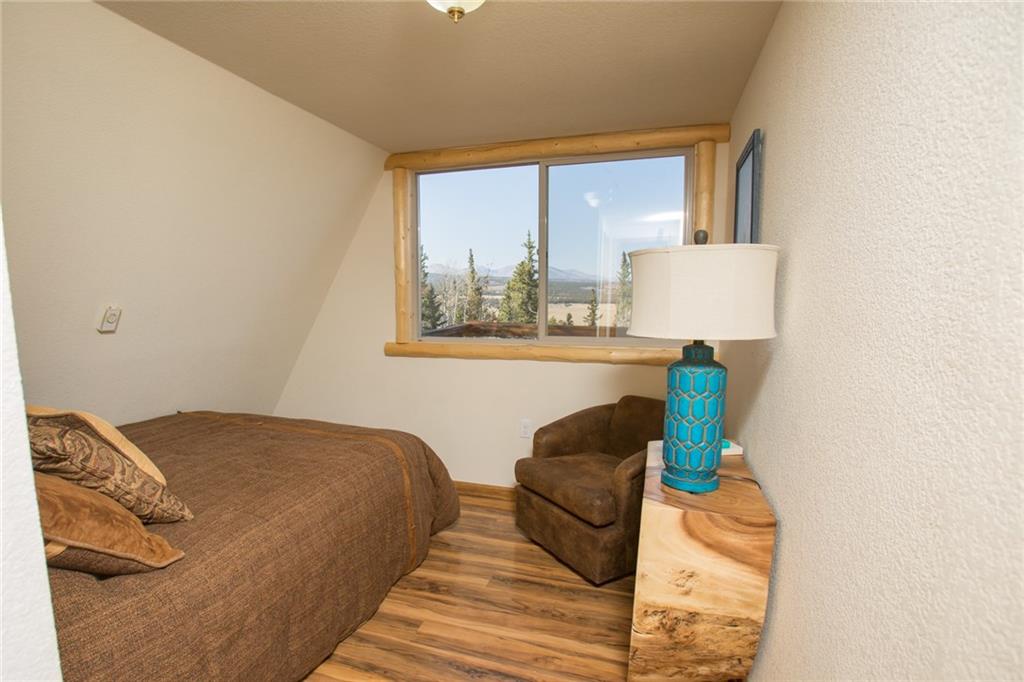 377 Sheep Ridge Road Fairplay, CO 80440 - Photo 21 of 35 a bedroom with a bed and a window