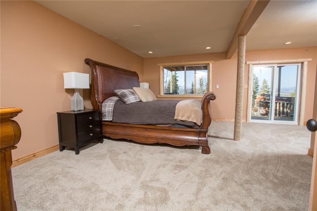 377 Sheep Ridge Road Fairplay, CO 80440 - Photo 27 of 35 a bedroom with a bed and a large window