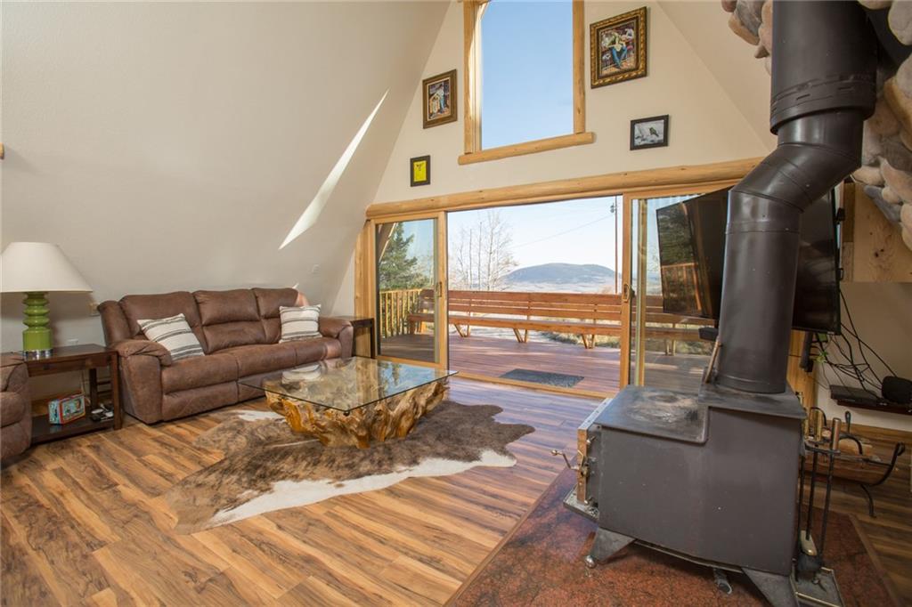 377 Sheep Ridge Road Fairplay, CO 80440 - Photo 5 of 35 a living room with furniture and a floor to ceiling window