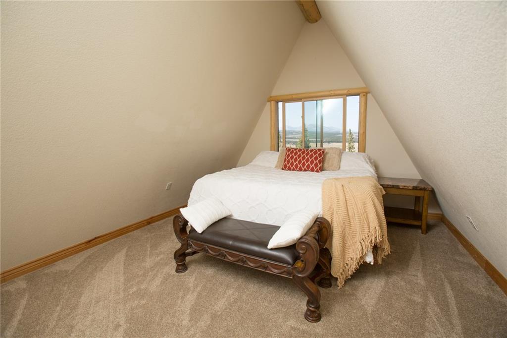 377 Sheep Ridge Road Fairplay, CO 80440 - Photo 8 of 35 a bedroom with a bed and a window