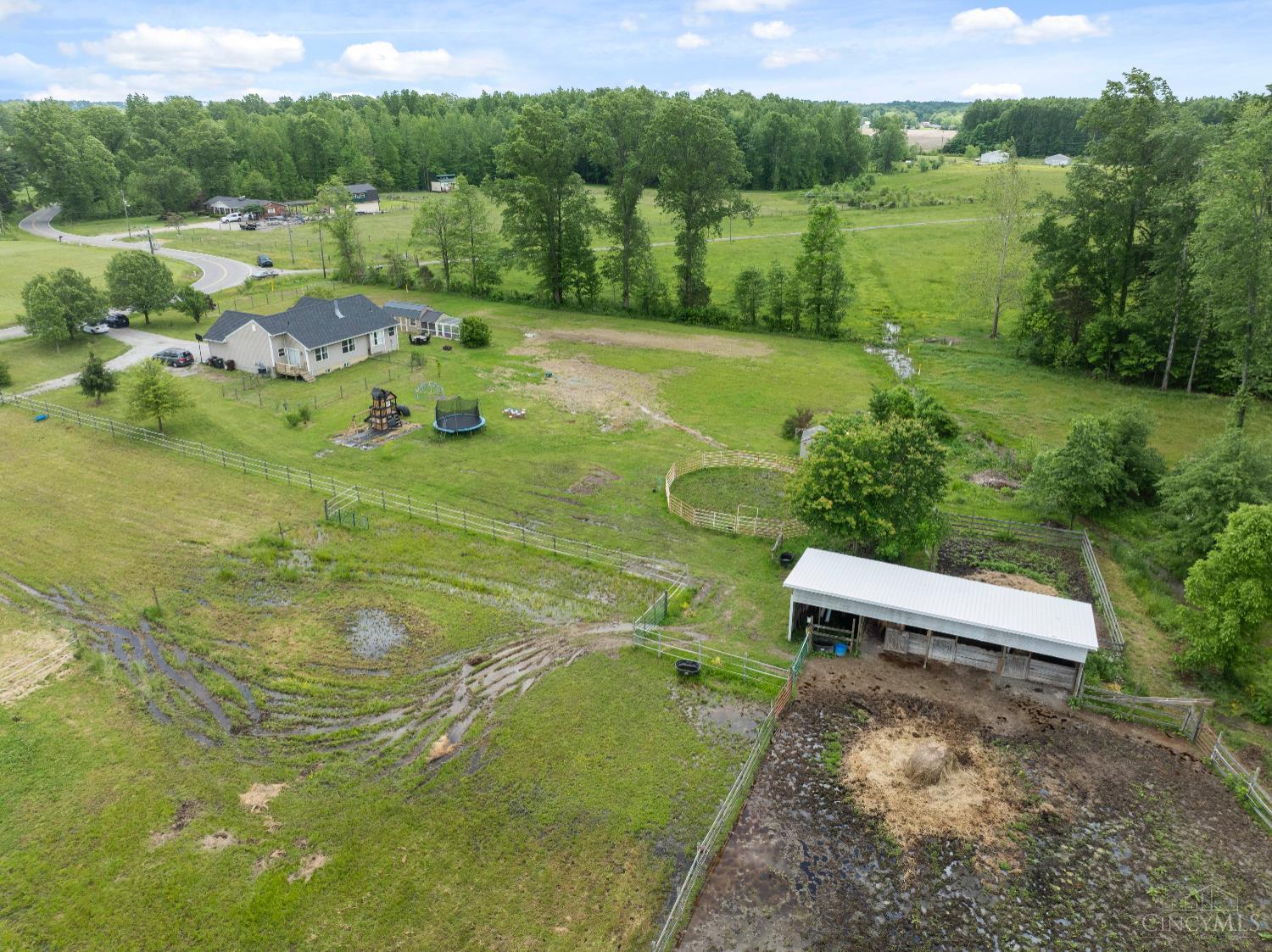2489 Swings Corner Point Isabel Road Bethel, OH 45106 - Photo 34 of 45 Shed row barn with 4 stalls. Open to 2 paddocks with cedar and poplar fencing reinforced with hard wired electric tape for added security in the 4 acres of fenced pasture.