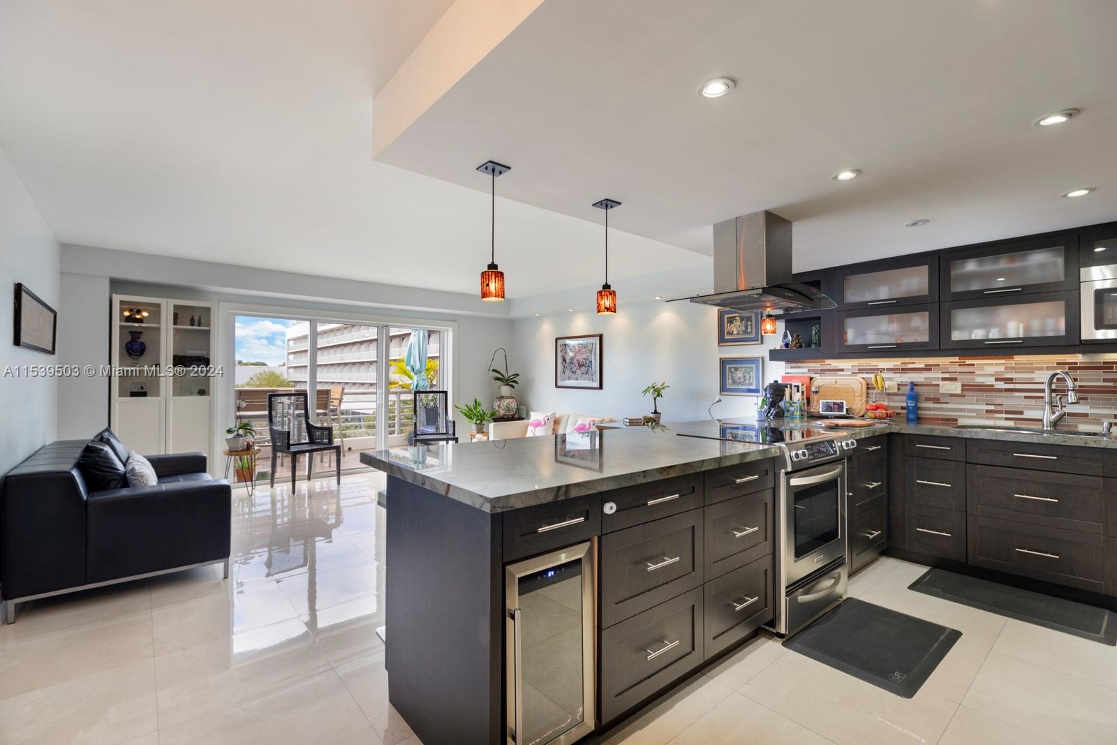 a kitchen with stainless steel appliances granite countertop a sink and a refrigerator