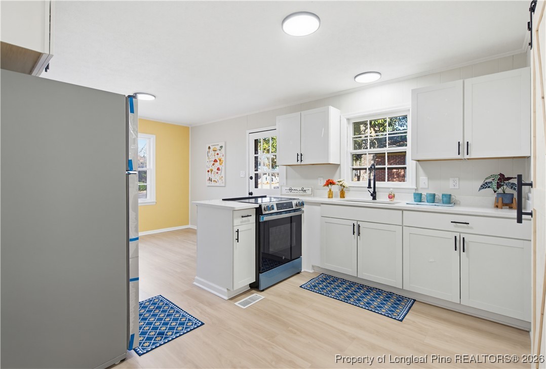 425 Ralph Street Fayetteville, NC 28301 - Photo 12 of 36 a kitchen with a sink cabinets and window