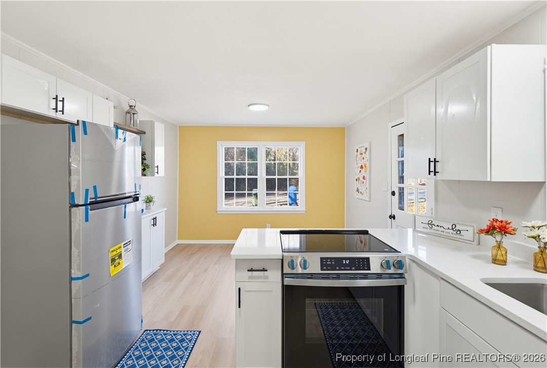 425 Ralph Street Fayetteville, NC 28301 - Photo 15 of 36 a kitchen with refrigerator and stove