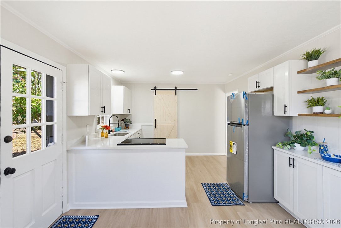 425 Ralph Street Fayetteville, NC 28301 - Photo 16 of 36 a kitchen with stainless steel appliances a refrigerator sink and white cabinets
