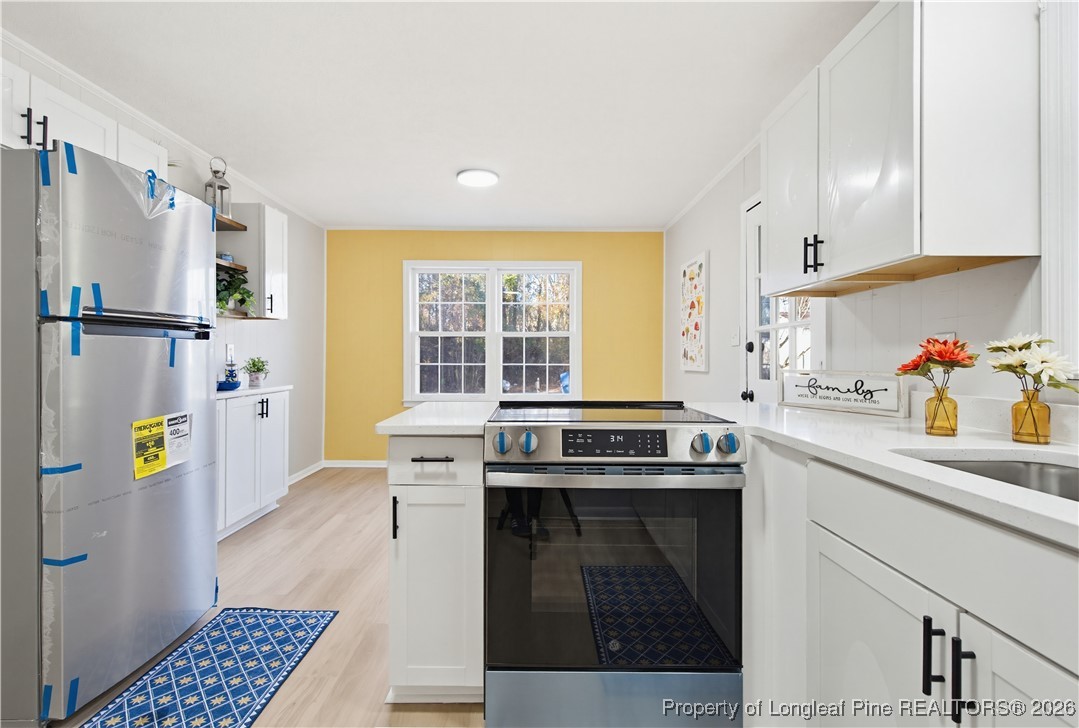 425 Ralph Street Fayetteville, NC 28301 - Photo 18 of 36 a kitchen with stainless steel appliances a stove a sink and a refrigerator