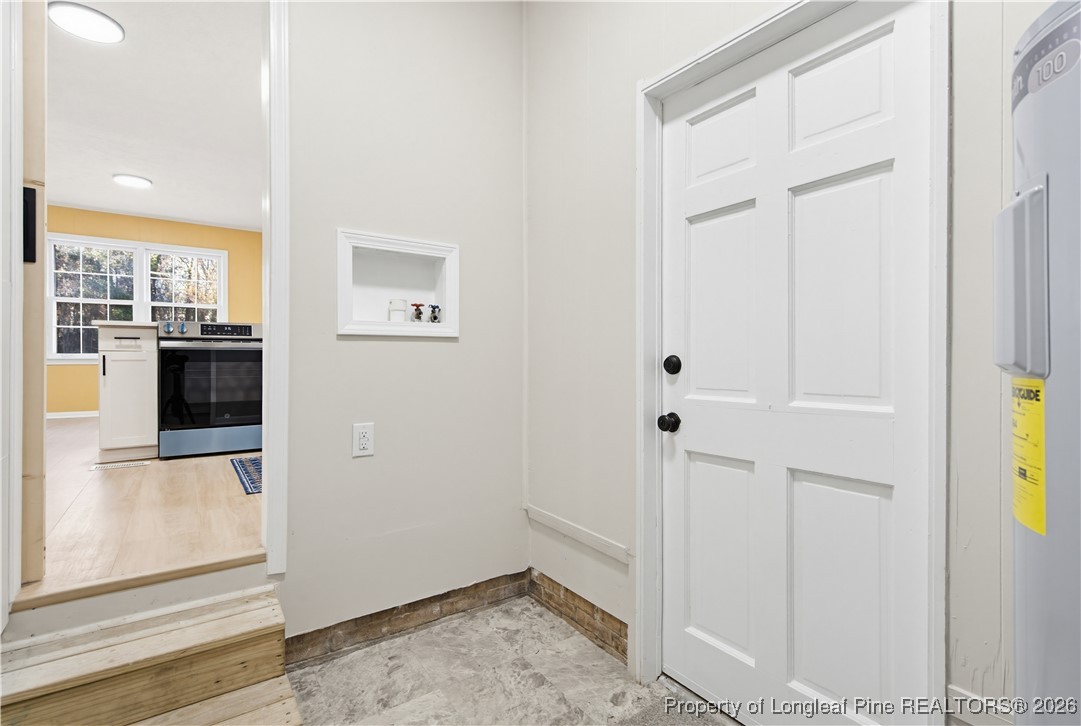 425 Ralph Street Fayetteville, NC 28301 - Photo 21 of 36 a view of a hallway with wooden floor and a living room