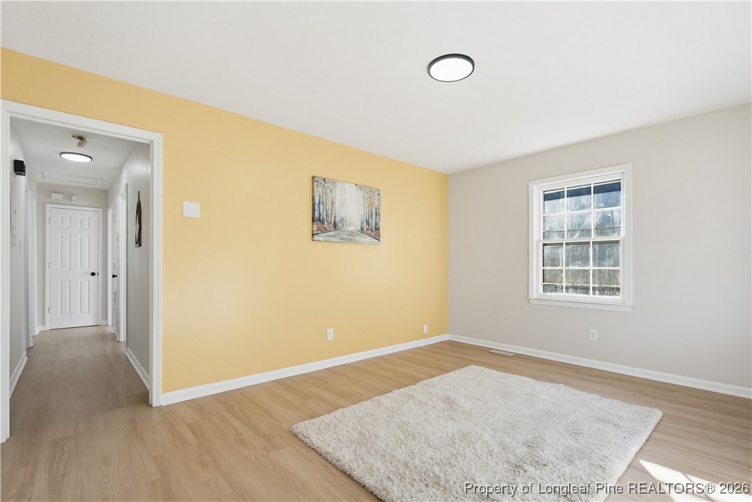 425 Ralph Street Fayetteville, NC 28301 - Photo 9 of 36 a view of an empty room with wooden floor and a window