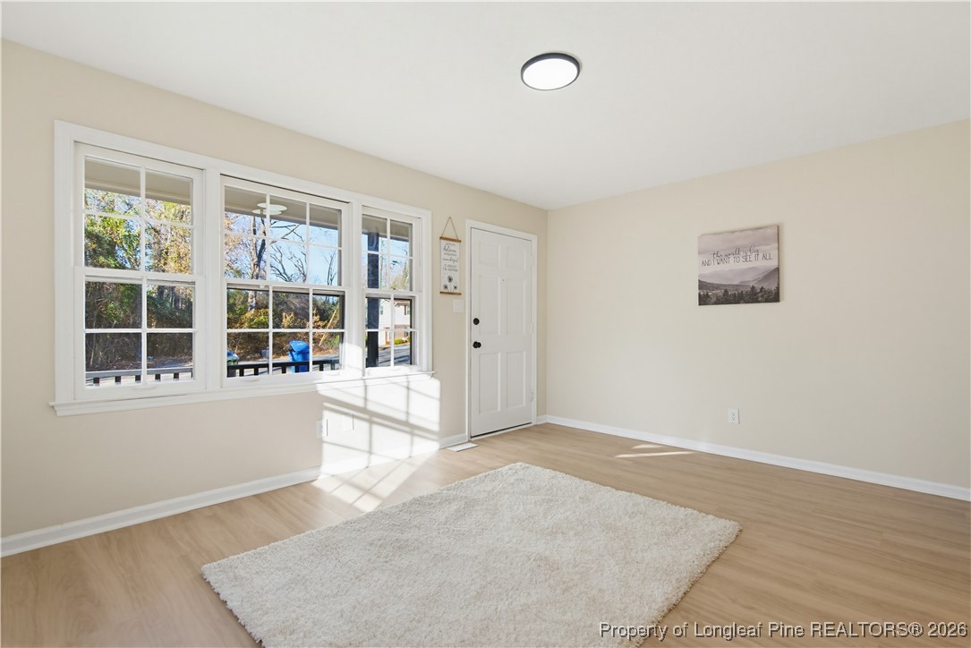425 Ralph Street Fayetteville, NC 28301 - Photo 10 of 36 an empty room with wooden floor and windows