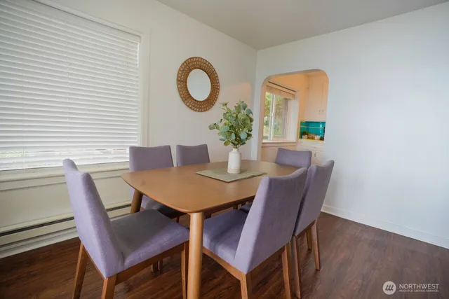 a view of a dining room with furniture and wooden floor