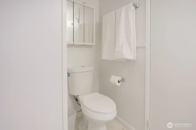 a white toilet sitting next to a shower