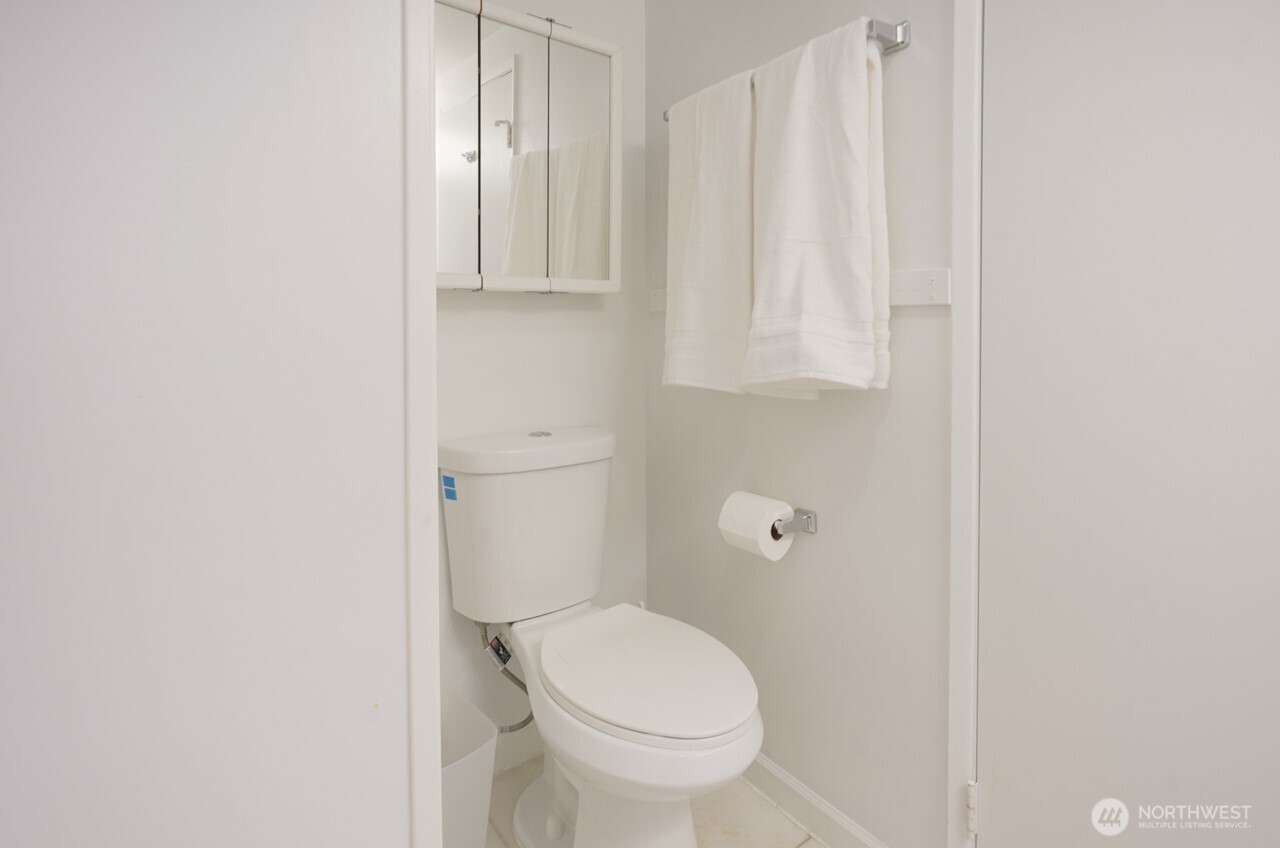 4027 Beach Drive Southwest, Unit 2 Seattle, WA 98116 - Photo 17 of 30 a white toilet sitting next to a shower