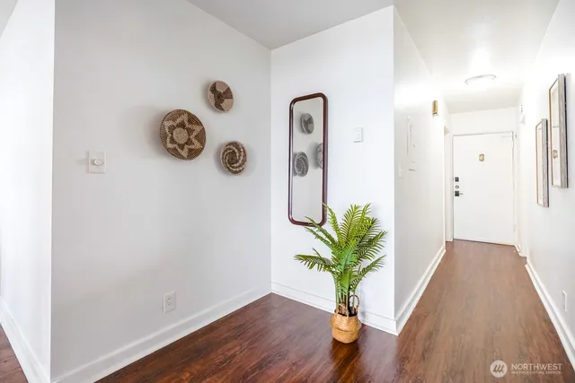 a view of an entryway with wooden floor