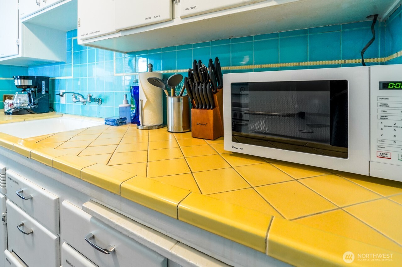 4027 Beach Drive Southwest, Unit 2 Seattle, WA 98116 - Photo 20 of 30 a room with window and a fireplace