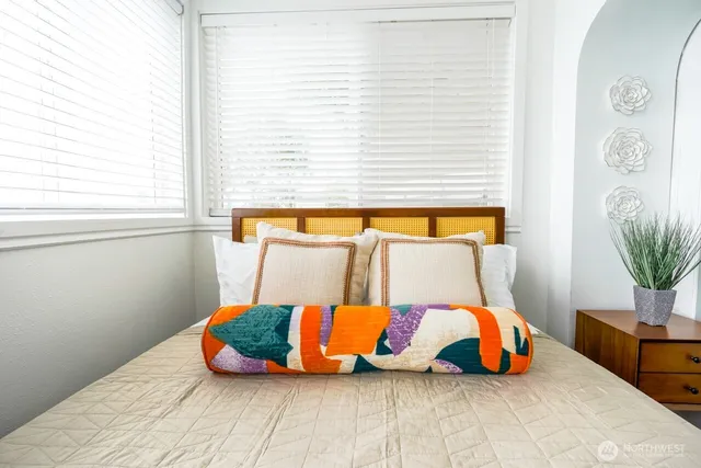 a bedroom with a bed and window