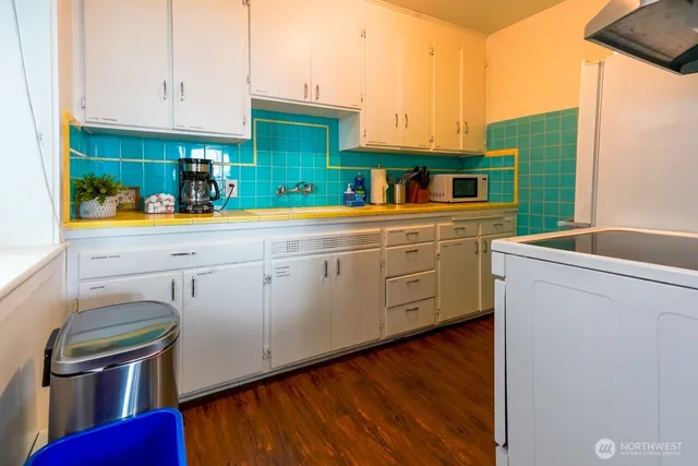 a kitchen with cabinets a sink and appliances