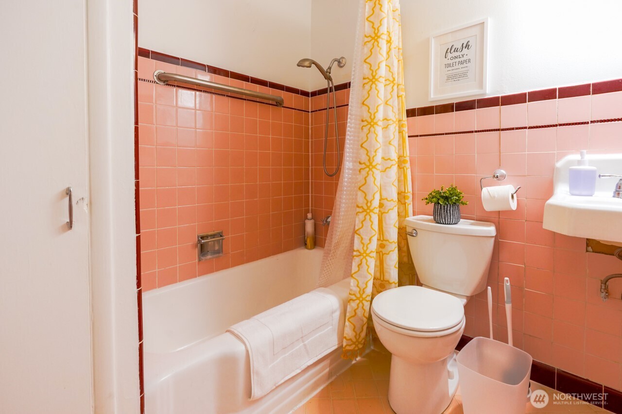4027 Beach Drive Southwest, Unit 2 Seattle, WA 98116 - Photo 23 of 30 a white toilet sitting next to a bath tub