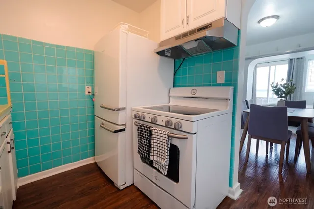 a bathroom with a sink a toilet a mirror and bathtub