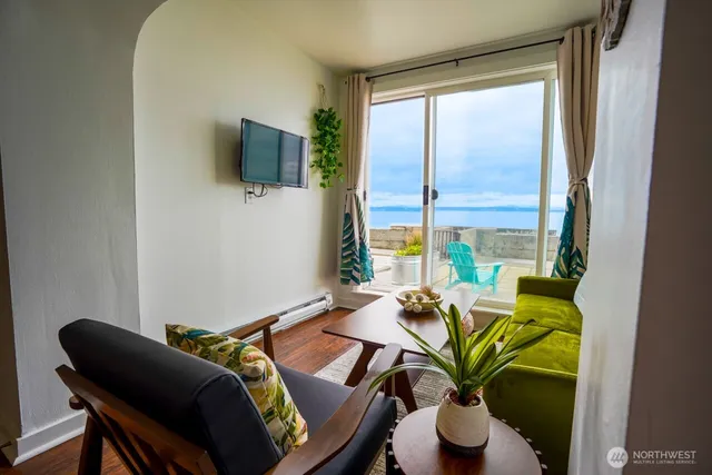 a living room with furniture and a potted plant