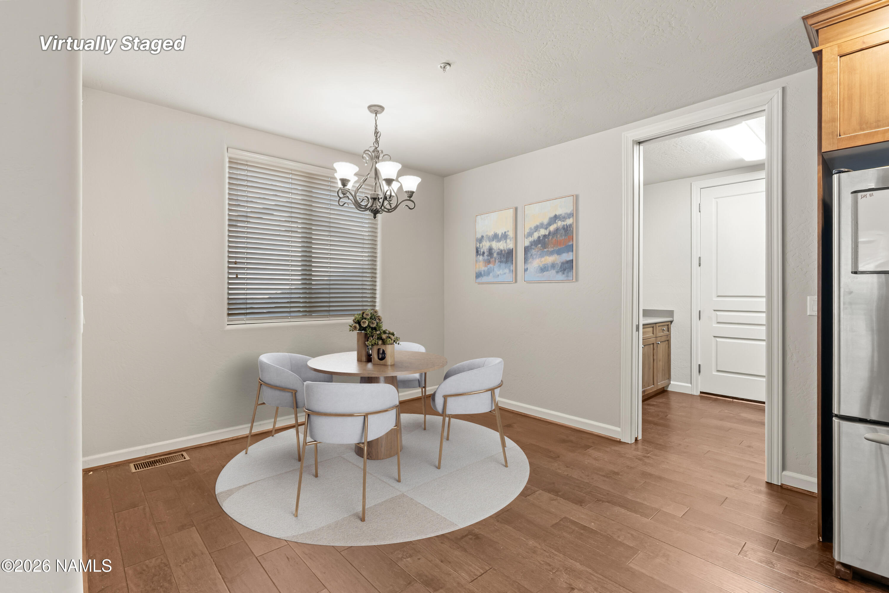 4860 West Quick Draw Flagstaff, AZ 86005 - Photo 10 of 32 a dining room with chandelier and wooden floor