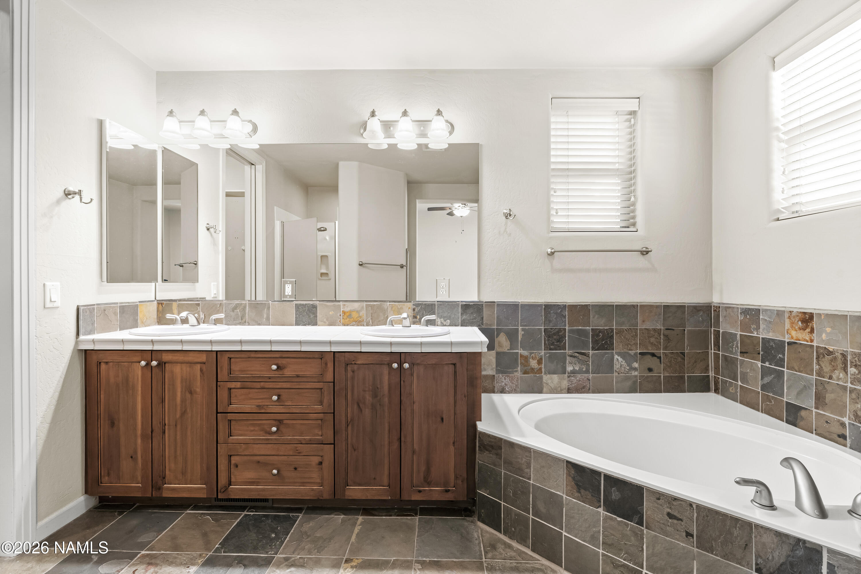 4860 West Quick Draw Flagstaff, AZ 86005 - Photo 13 of 32 a bathroom with a tub a sink and mirror