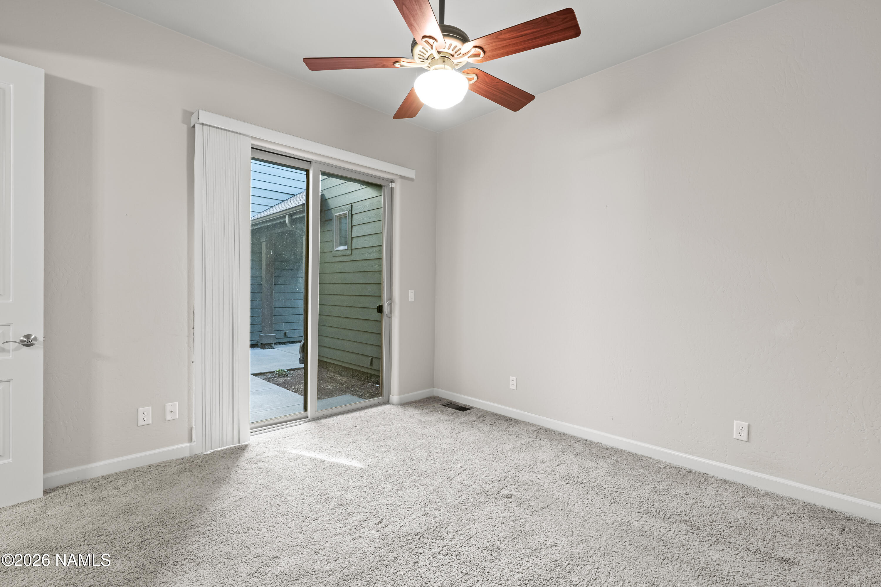 4860 West Quick Draw Flagstaff, AZ 86005 - Photo 19 of 32 an empty room with chandelier fan