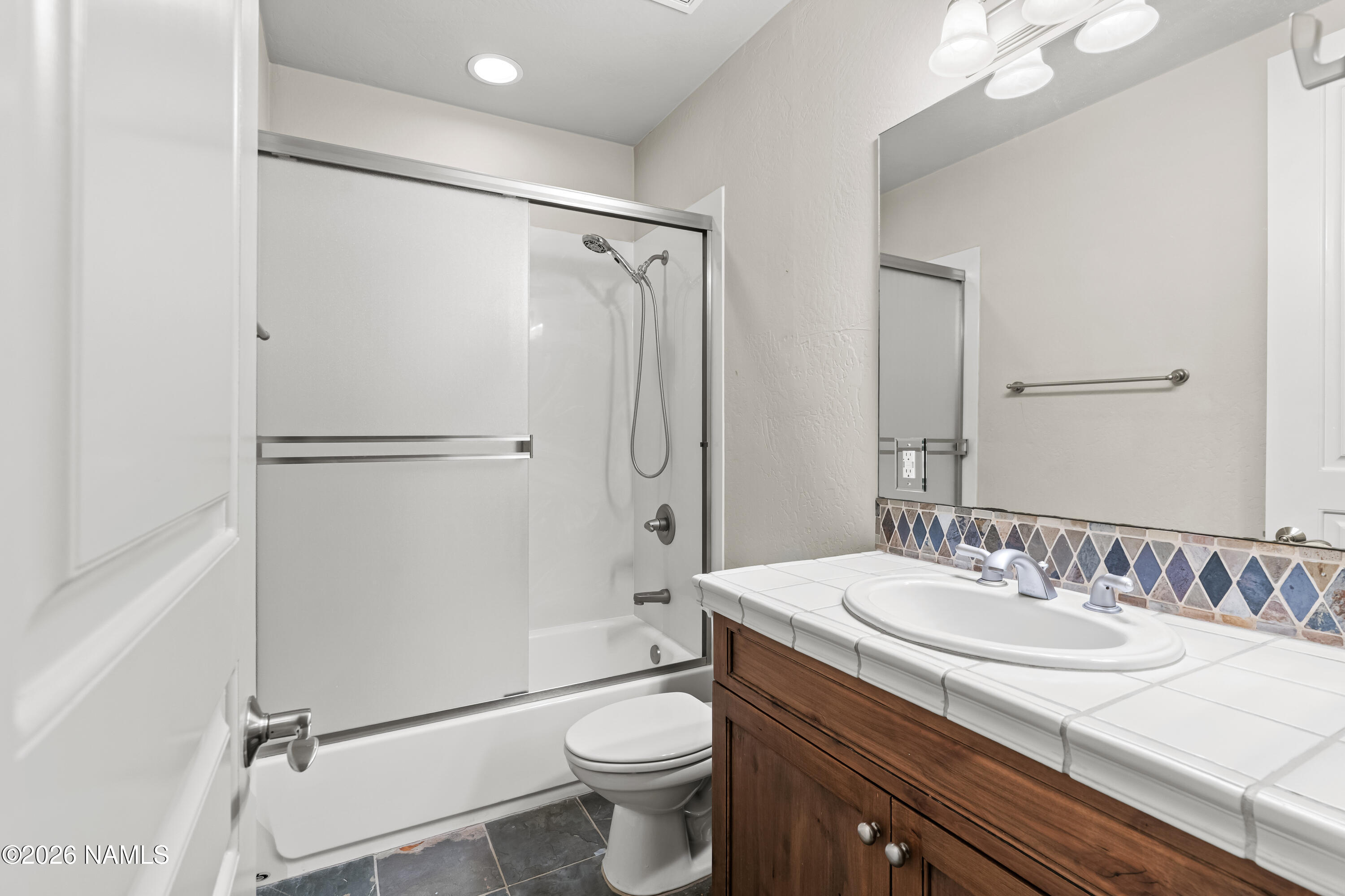 4860 West Quick Draw Flagstaff, AZ 86005 - Photo 20 of 32 a bathroom with a granite countertop sink toilet and shower