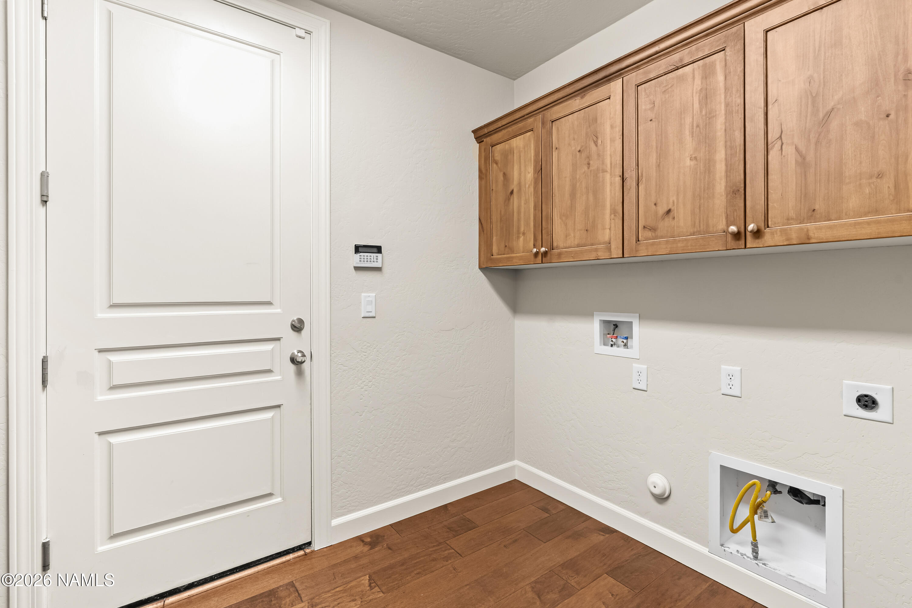4860 West Quick Draw Flagstaff, AZ 86005 - Photo 24 of 32 a view of an empty room with wooden floor and cabinet