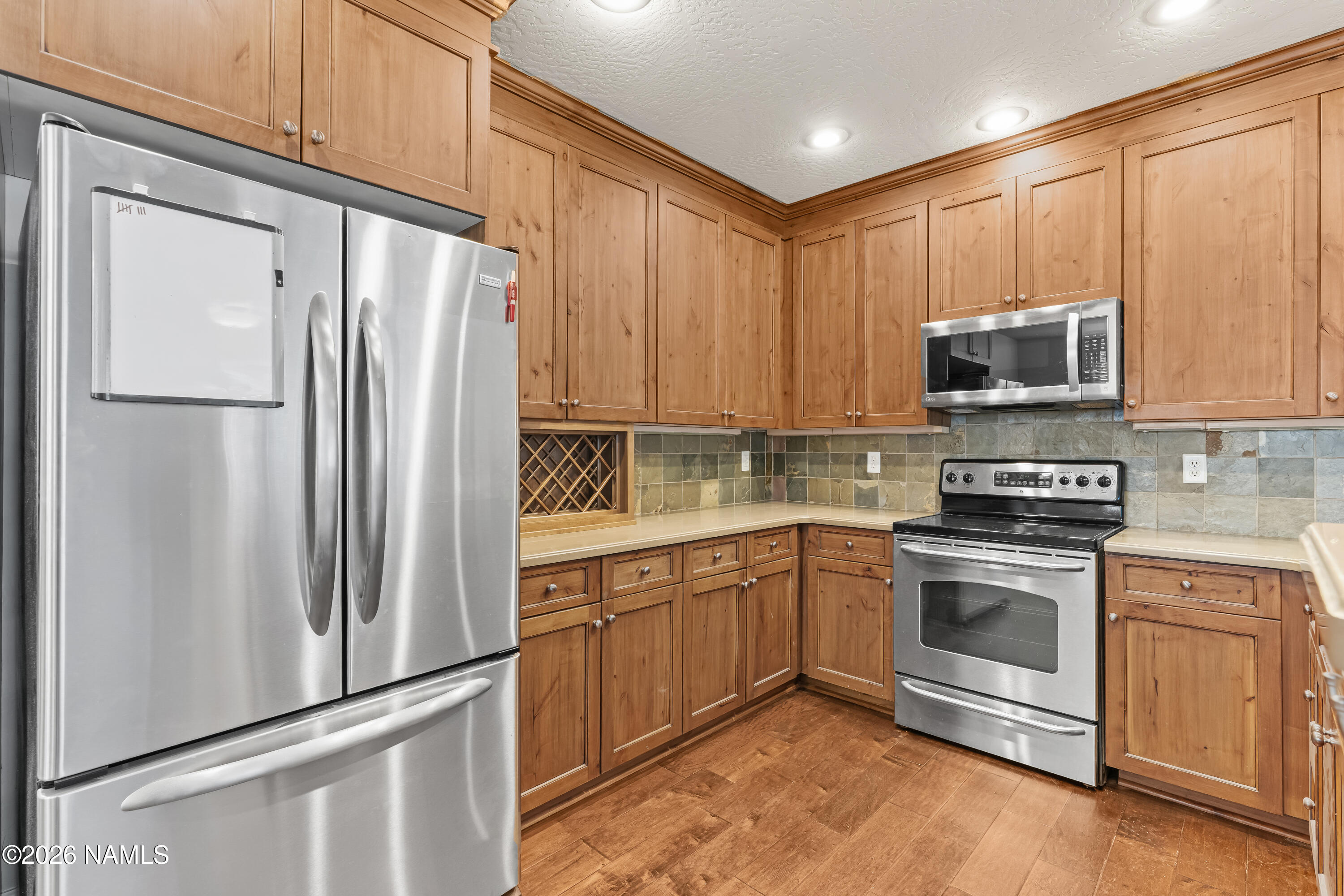 4860 West Quick Draw Flagstaff, AZ 86005 - Photo 6 of 32 a kitchen with stainless steel appliances granite countertop a refrigerator stove and sink