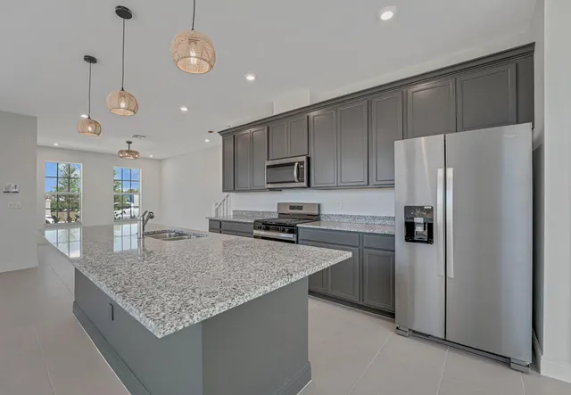a view of a kitchen with a sink and chandelier