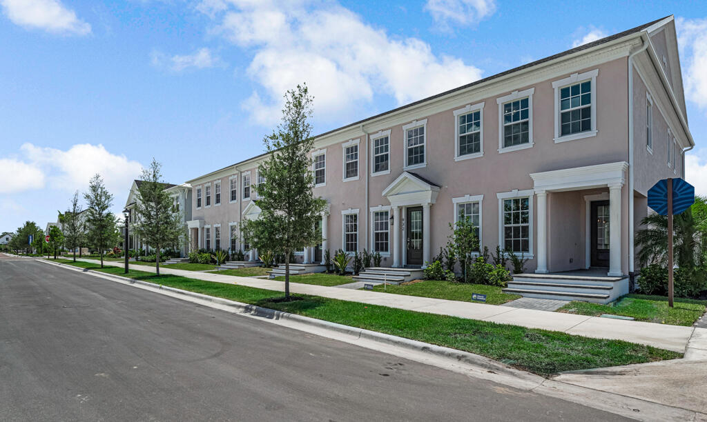 930 Southwest Pr Avenue Palm City, FL 34990 - Photo 2 of 66 a front view of a house with a yard