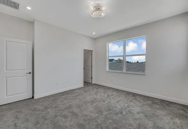 a view of an empty room and a window