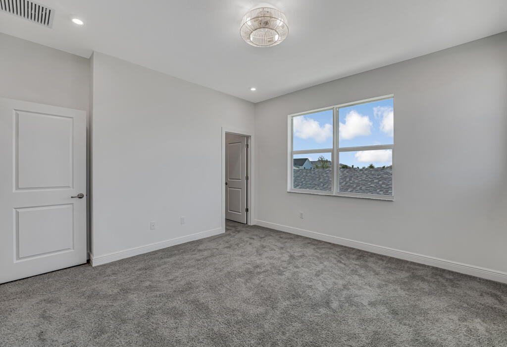 930 Southwest Pr Avenue Palm City, FL 34990 - Photo 22 of 66 an empty room with windows and closet
