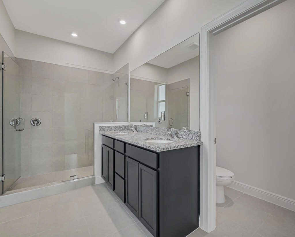 930 Southwest Pr Avenue Palm City, FL 34990 - Photo 24 of 66 a bathroom with a sink a toilet and shower