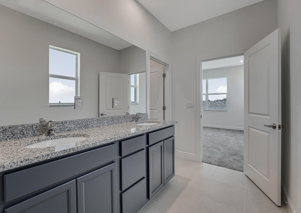 930 Southwest Pr Avenue Palm City, FL 34990 - Photo 25 of 66 a bathroom with a granite countertop sink mirror and double