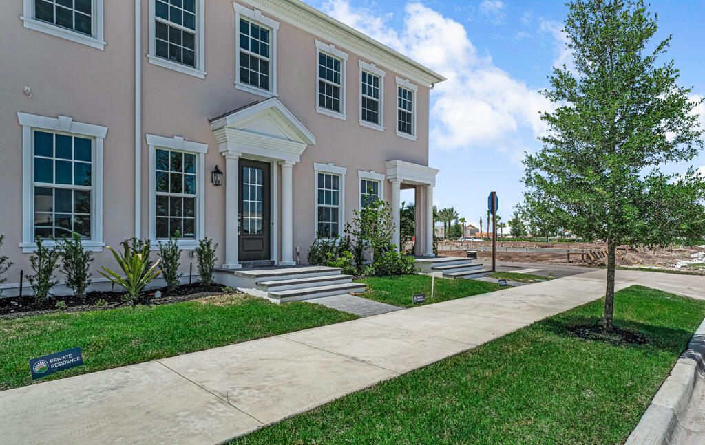 930 Southwest Pr Avenue Palm City, FL 34990 - Photo 3 of 66 a view of a brick house with a yard and plants