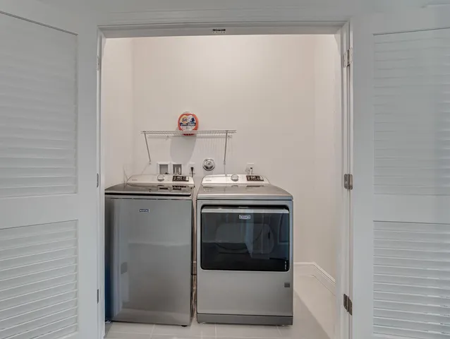 a house with outdoor space and trees in the background