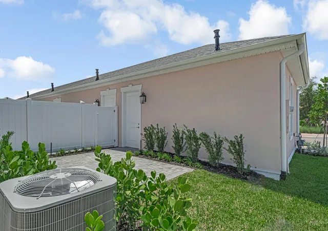 a front view of house with yard and mountain view in back