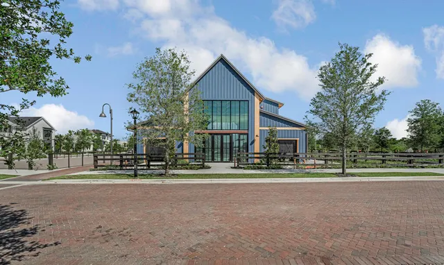 an aerial view of a house with a garden and lake view