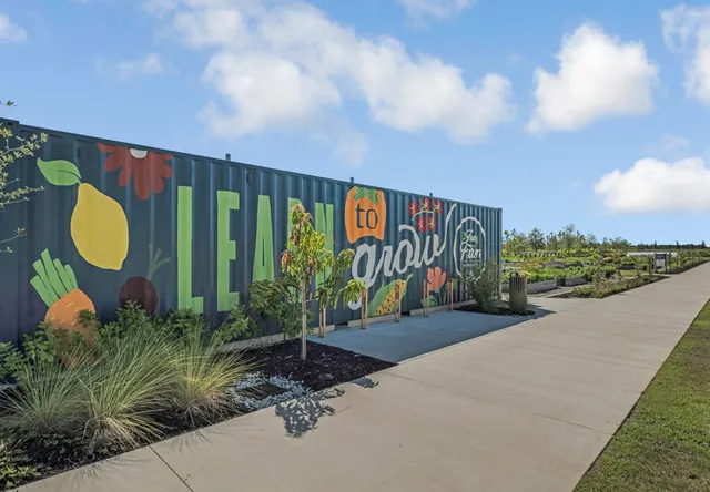 a aerial view of a house with a garden and lake view