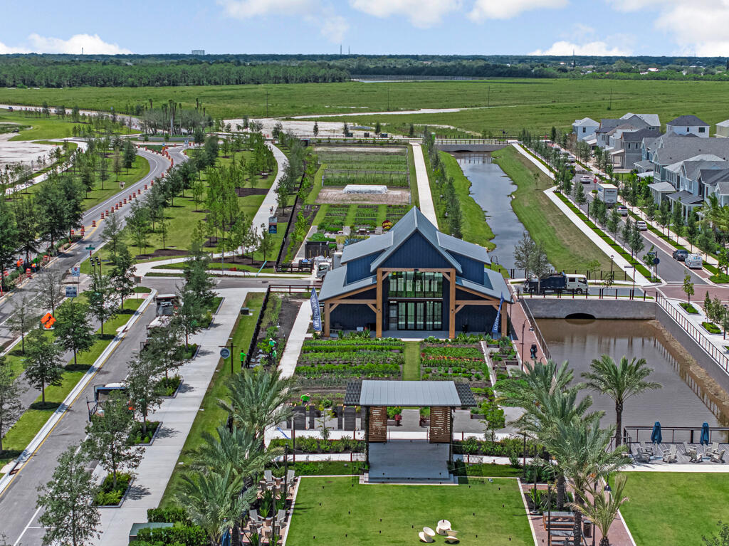 930 Southwest Pr Avenue Palm City, FL 34990 - Photo 59 of 66 an aerial view of a house with a garden and lake view