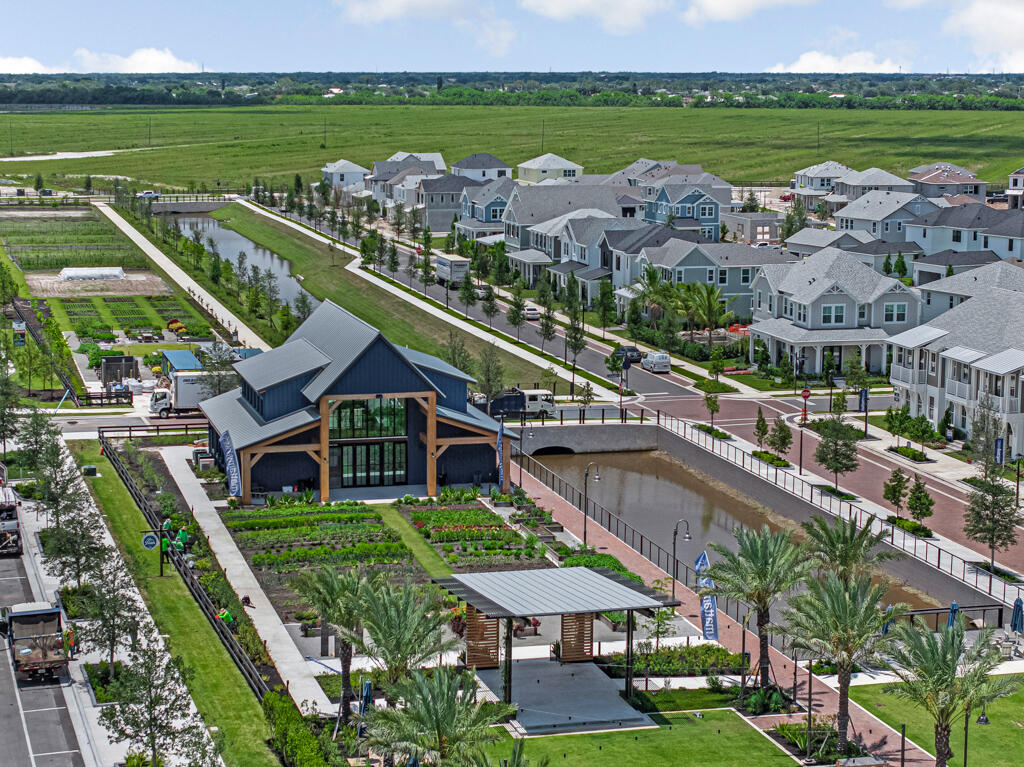 930 Southwest Pr Avenue Palm City, FL 34990 - Photo 60 of 66 a aerial view of a house with a garden and lake view