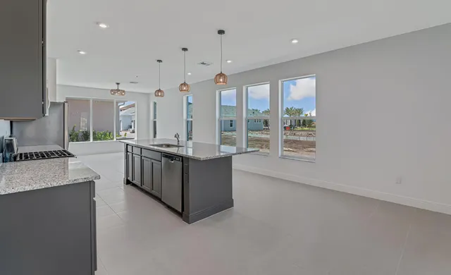 a kitchen with stainless steel appliances sink cabinets and wooden floor