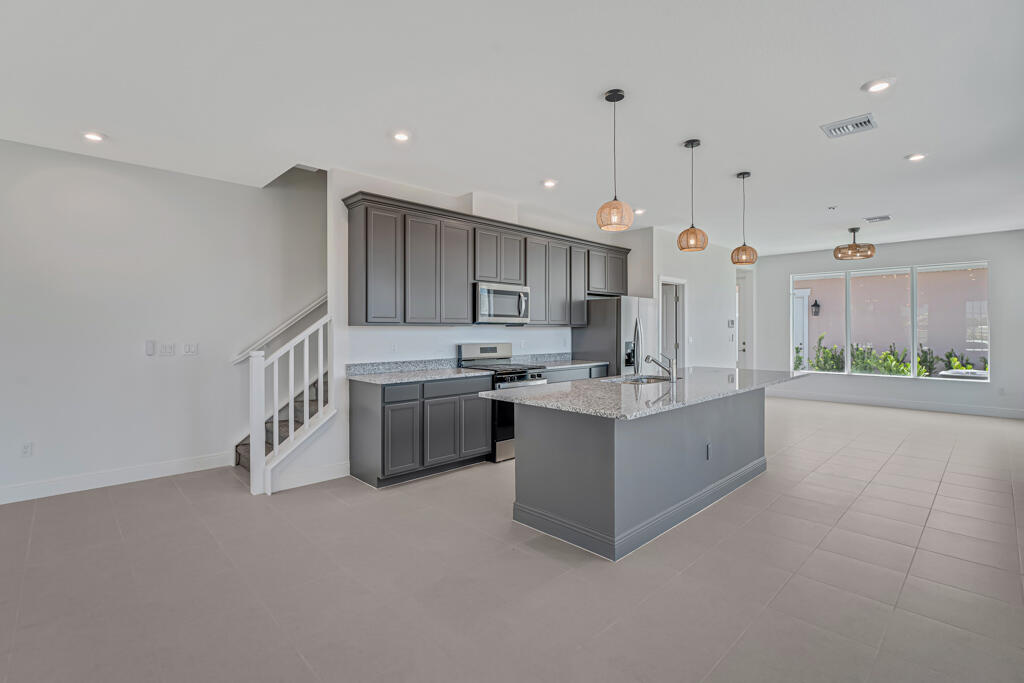 930 Southwest Pr Avenue Palm City, FL 34990 - Photo 9 of 66 a kitchen with stainless steel appliances sink cabinets and wooden floor